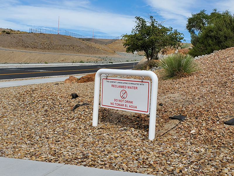 Public signage stating “The Sunport landscaping is irrigated with reclaimed water – do not drink (no tomar el agua)”